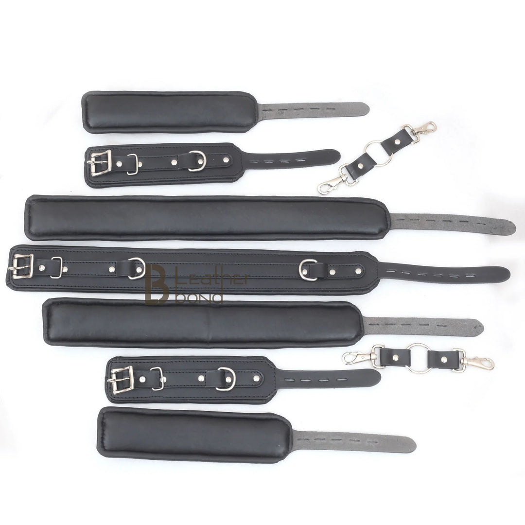 Underside view of the black leather bondage cuffs showing the plush padded lining for comfort, part of an adult restraint set for BDSM play.