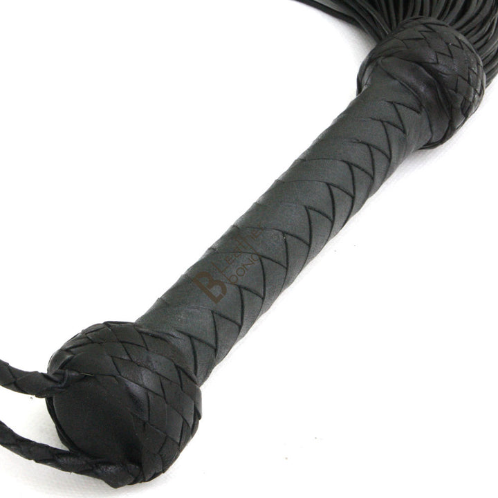 Braided handle and wrist loop on leather flogger, crafted for control in BDSM flogger scenes and stingy flogger whip play