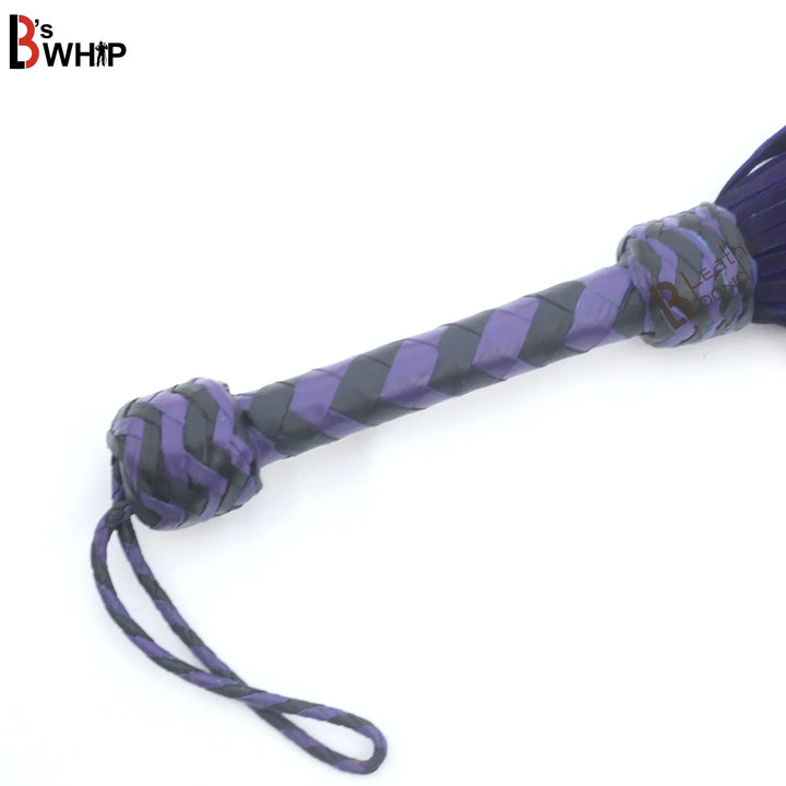 Braided leather handle and wrist loop on purple and black BDSM flogger whip, handcrafted for balance during flogger spanking and flogger sex.