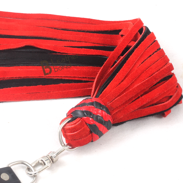 Close-up of 50 real leather falls on a red and black BDSM flogger whip, designed for rhythmic flogger spanking and deep flogger sex scenes.