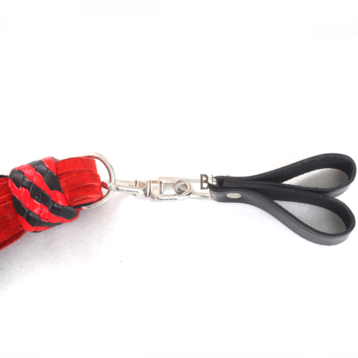 Finger loop grip of red and black leather flogger, offering precise control for flogger sex, flogger spanking, and BDSM flogger performance