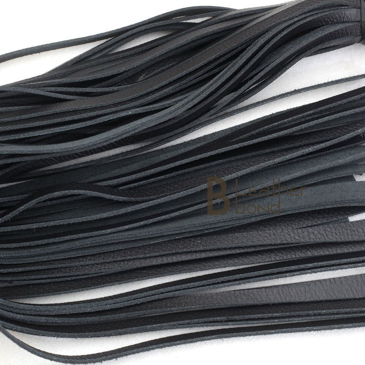 Close-up of 25 real leather falls on a heavy-duty BDSM flogger, designed for deep impact flogger spanking and high-intensity flogger sex play.